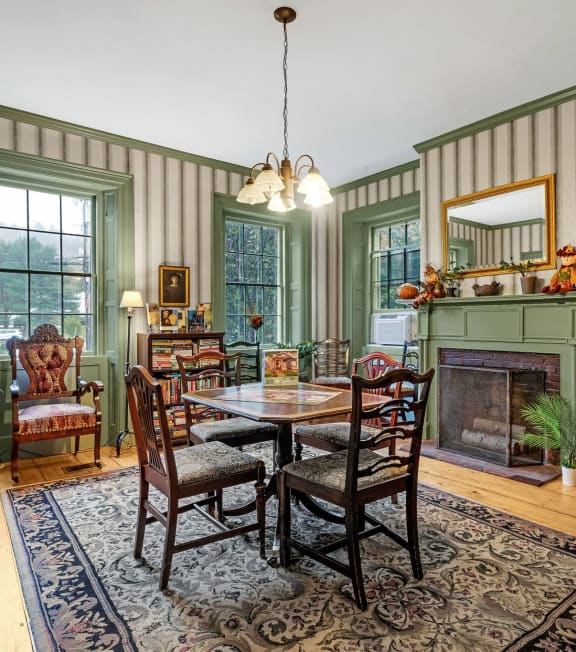 a dining room with a table and chairs and a fireplace