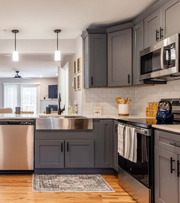 A modern kitchen with a large island and stainless steel appliances.