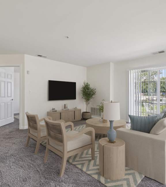 A living room with a grey carpet and a white sofa.