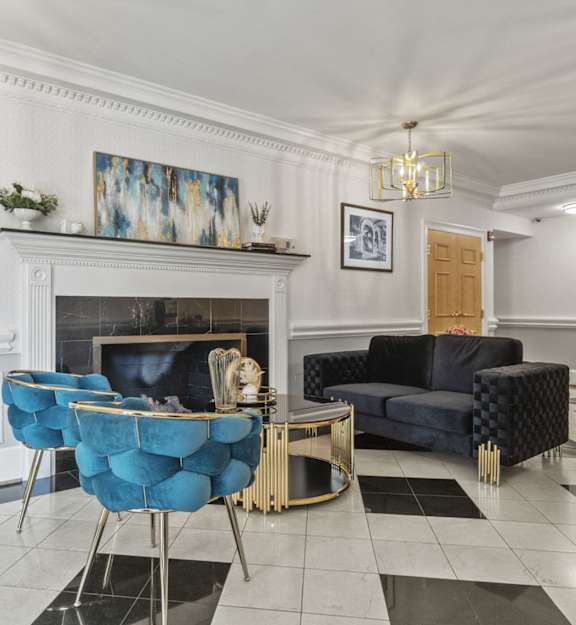 a living room with a fireplace and a black and white checkered floor