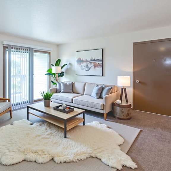 a white bedroom with a large bed and a window