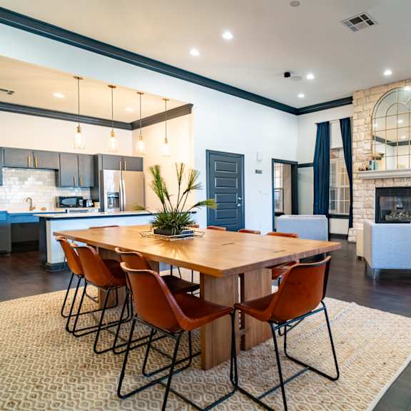 a kitchen and living room with a table and chairs