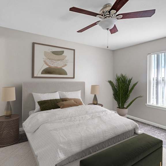 A bedroom with a large bed, a ceiling fan, and a painting on the wall.