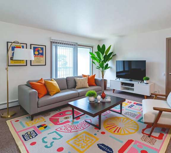 a living room with a couch and a table and a television