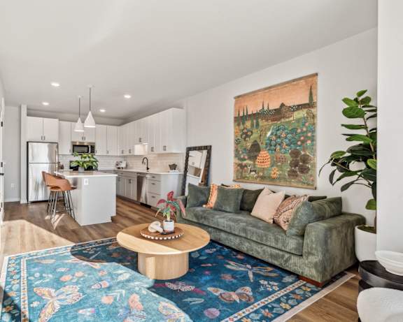 A living room with a couch, a coffee table, and a television.