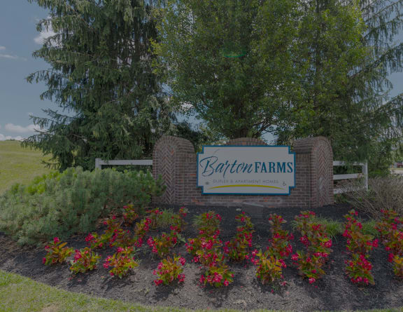 the sign at the entrance to bath farms with flowers