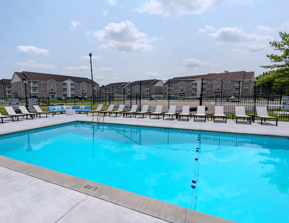our resort style swimming pool is next to our building with lounge chairs