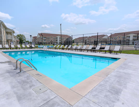 our resort style swimming pool is next to our building with lounge chairs