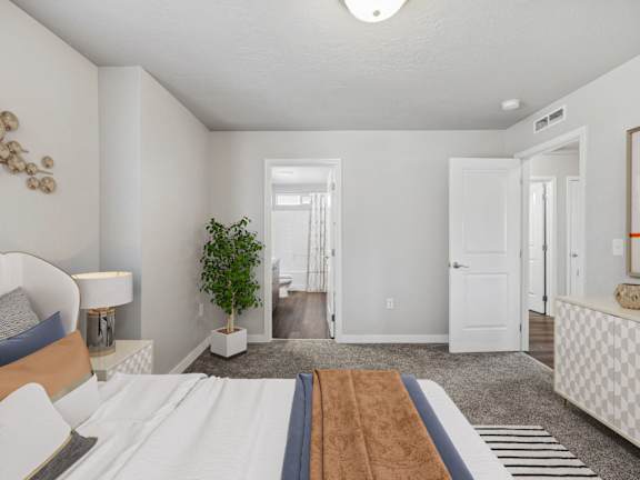 a bedroom with a large bed and a door to a hallway