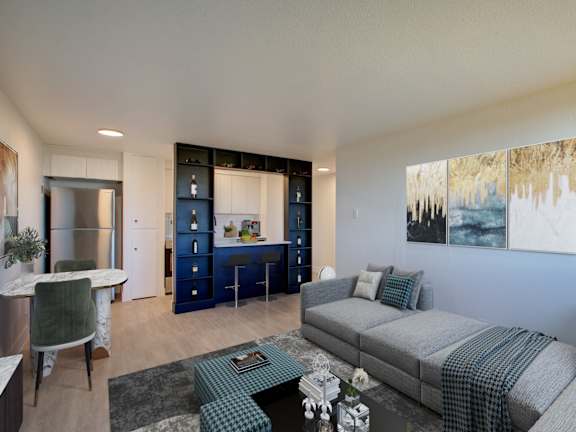 A living room with a grey couch and a green chair.