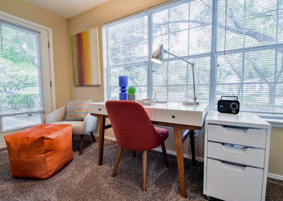 a home office with a desk and chair and a large window at Riverset Apartments, Memphis, 38103