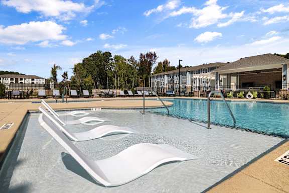 A large swimming pool with a slide in the middle.