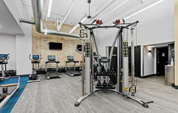 a gym with cardio equipment and a tv in a building  at The Cosmopolitan, Minnesota, 55101