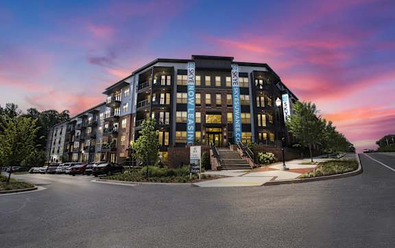 A modern building with the word "EXCELLENCE" on the front.