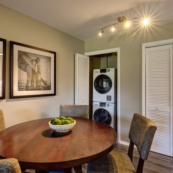a dining room with a table and chairs and a washing machine
