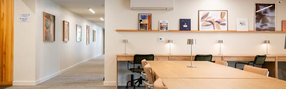 A conference room with a long table and chairs.