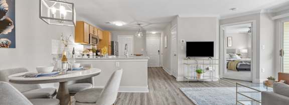 A modern kitchen with a dining table and chairs.