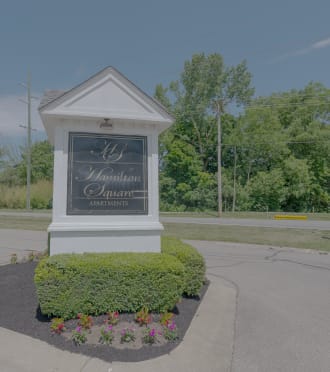 the sign at the entrance to bath farms with flowers