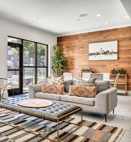 a living room filled with furniture and a large window