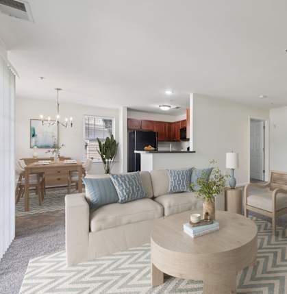 A living room with a couch, chairs, and a coffee table.