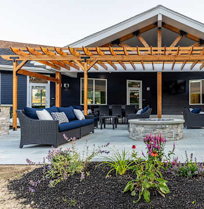 A patio with a pergola and outdoor furniture.