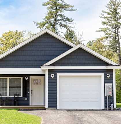 A two-car garage with a white door and a small porch.