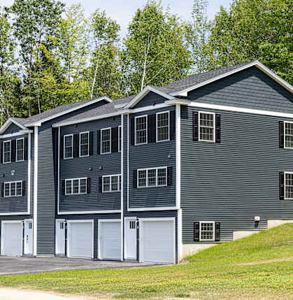 A grey house with a white garage door.