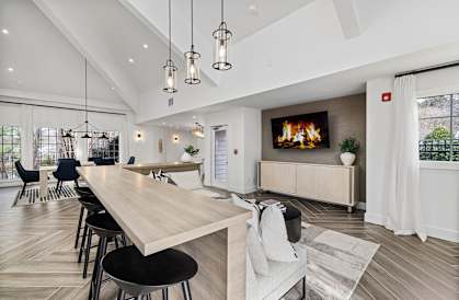 a living room with a fireplace and a table and chairs