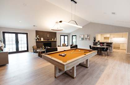 a pool table in the center of a living room