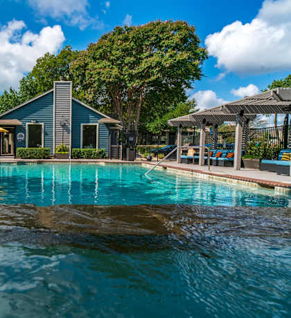 a swimming pool with a house in the background
