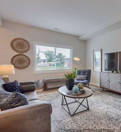A living room with a grey chair and a coffee table.