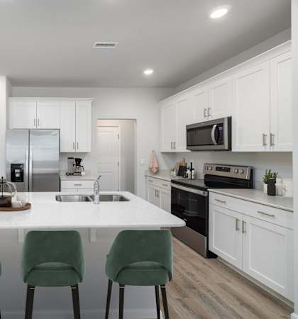 a kitchen with white cabinets and a white counter top