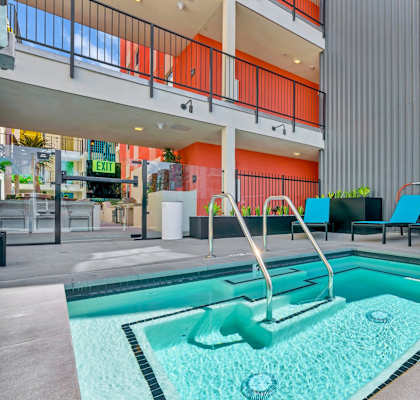 A pool with a slide in the middle of it.