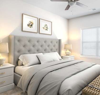a bedroom with a large bed in front of a window with blinds