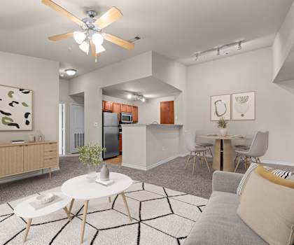 A modern living room with a grey couch and a white coffee table.