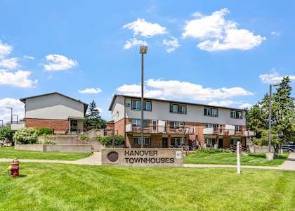 the view of hanover townhouses with a fire hydrant in the grass