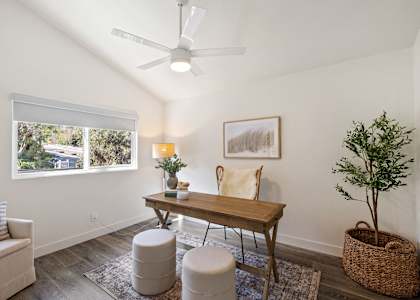 a living room with white walls and a table with chairs
