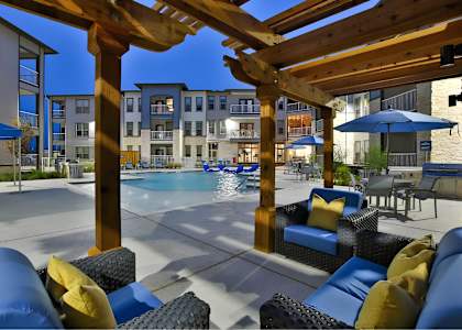 our apartments have a large swimming pool with chairs and umbrellas