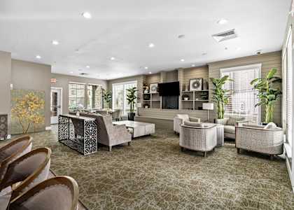 A spacious living room with a patterned carpet and furniture.
