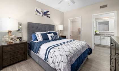 a bedroom with a bed and a ceiling fan