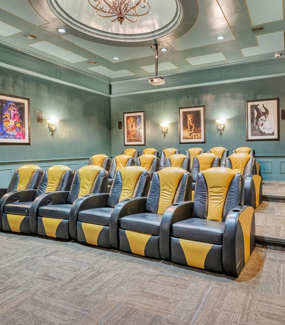 a theater room with blue and yellow chairs and a chandelier at Vintage Park Apartments, Houston, 77070