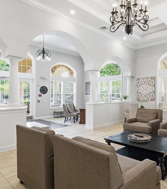 A spacious gym with a variety of equipment and a large window. at Park Place Oviedo Apartments, Oviedo, FL
