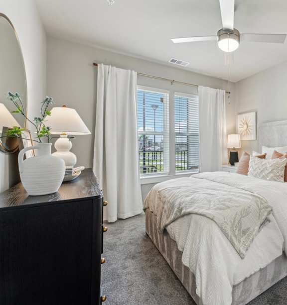 A modern kitchen with a white table and grey chairs at The Hendry Apartments, Fort Myers, FL, 33905