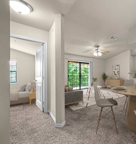 A room with a ceiling fan and a kitchenette.