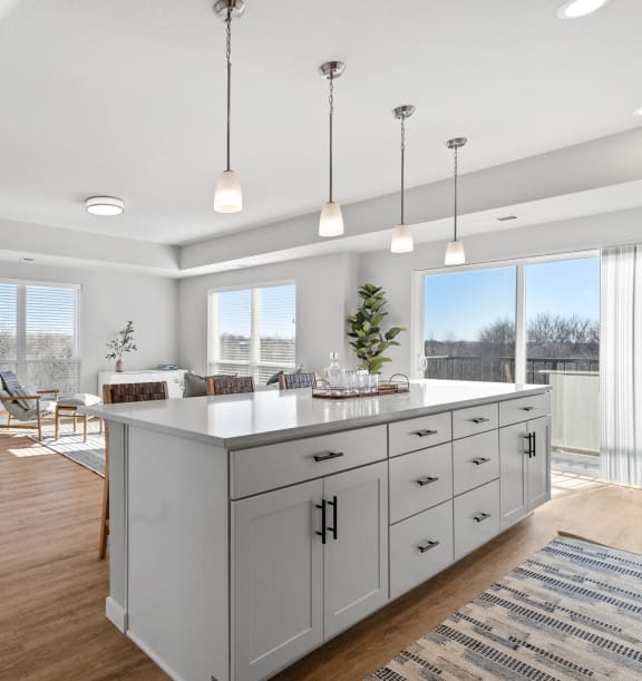 an open concept kitchen and living room with a large white island