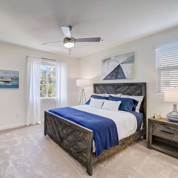 a bedroom with a bed and a ceiling fan