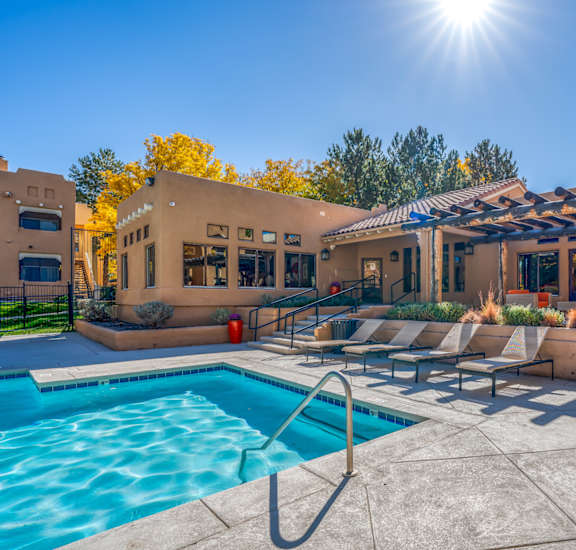 A pool area with a sunny sky above.