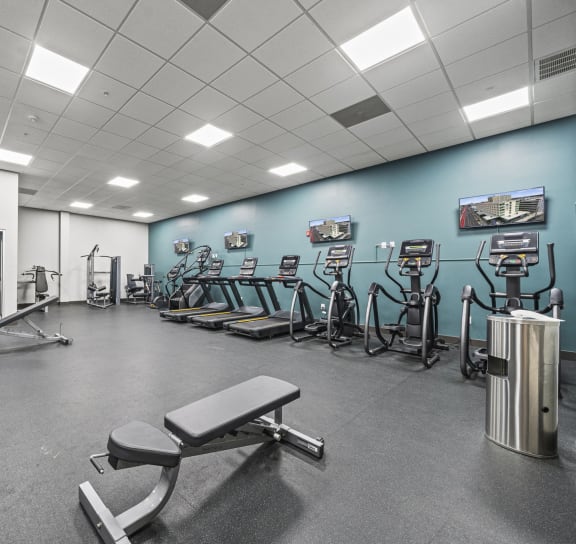 a large fitness room with cardio equipment and weights  at The Icon, Virginia, 23230