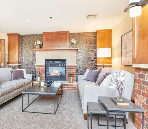 a living room with couches and a fireplace