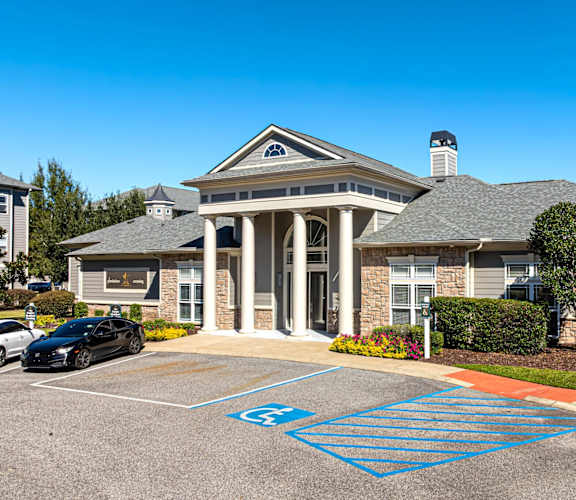 A car is parked in a blue handicapped parking spot.